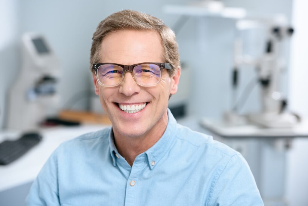 portrait of smiling middle aged man in eyeglasses